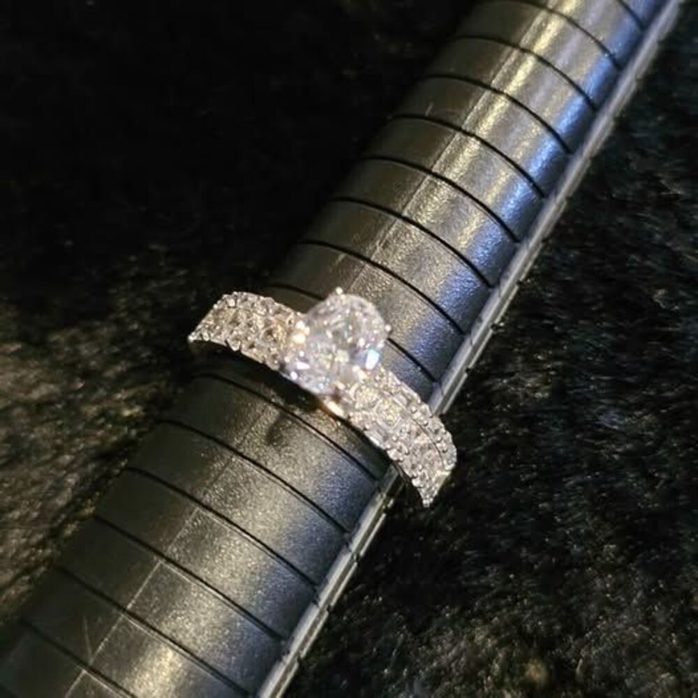 Sterling Silver setting with over 2CTW of CZ's and moissanite. Size 9.25